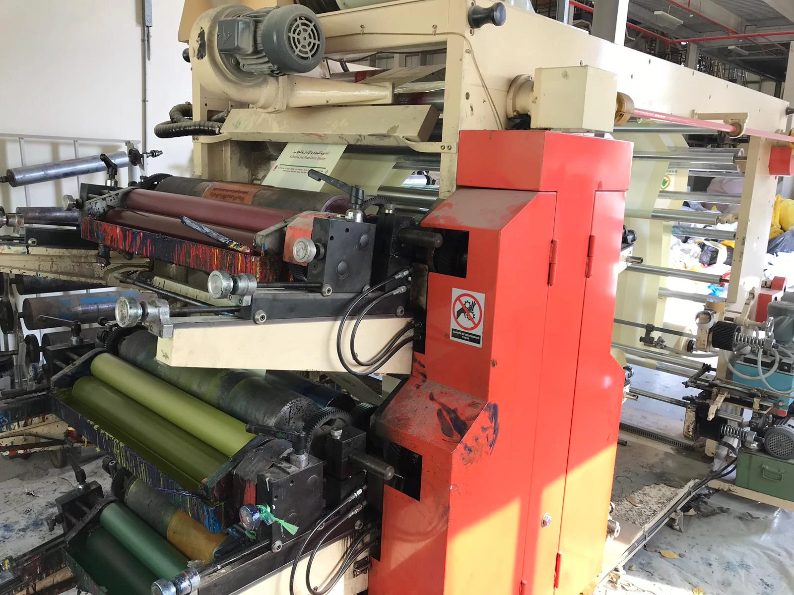 Flexographic printing press processing printed film at the Bin Aman factory