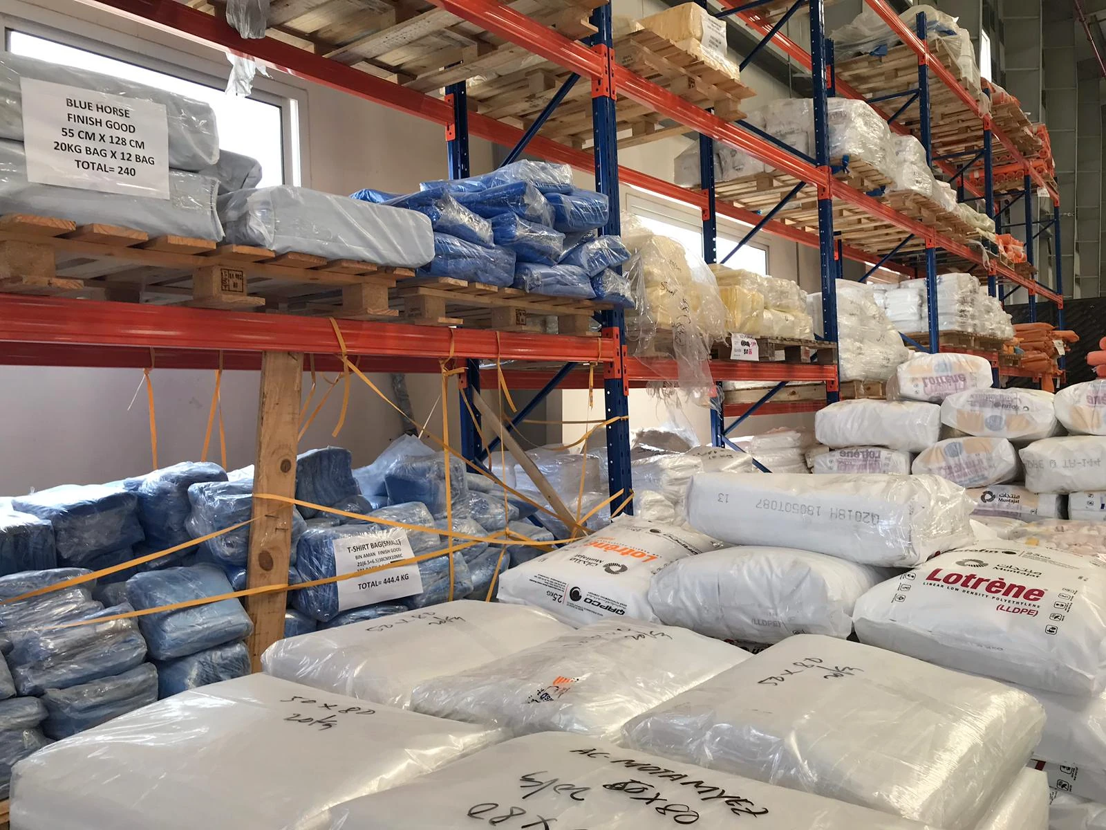 Raw materials and packed stock on warehouse shelving at Bin Aman