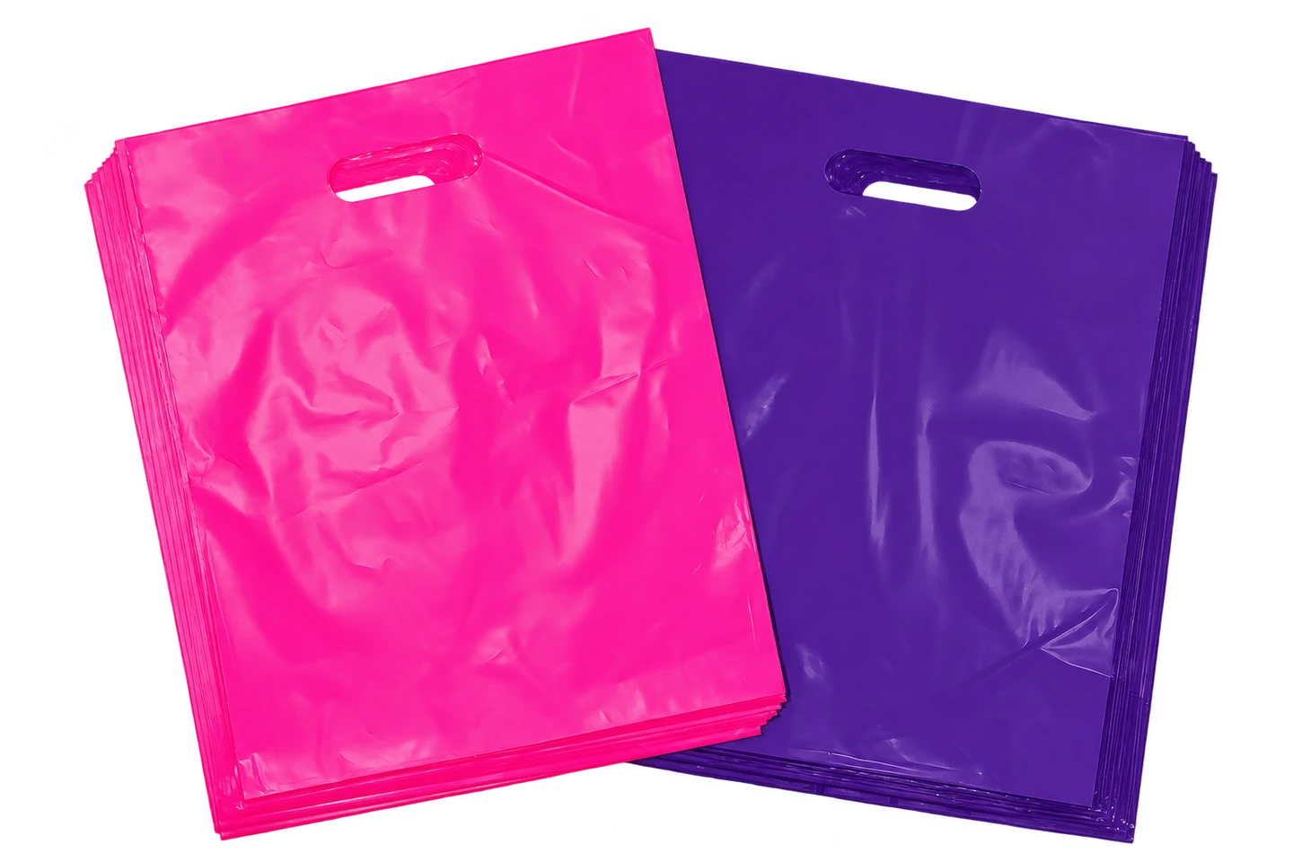 Stacks of plain pink and purple die-cut carrier bags